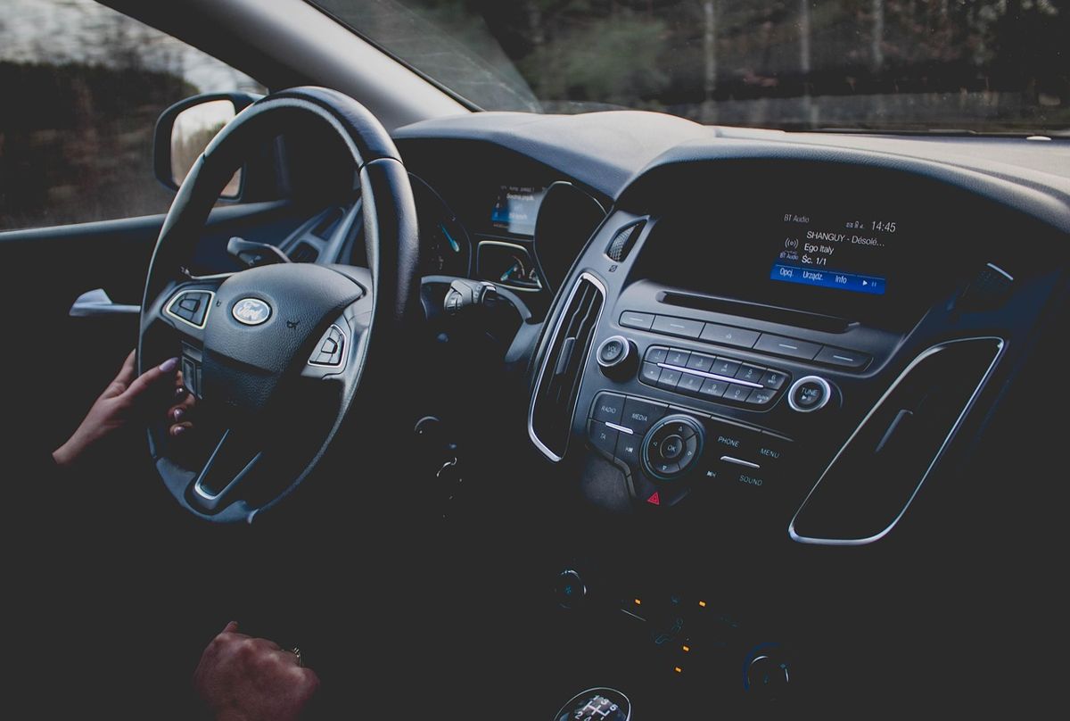 Car steering wheel and dashboard at night