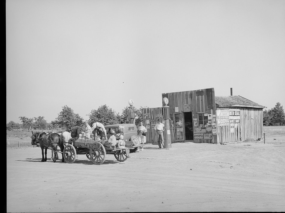 Horse-drawn wagon and customers outside a crossroads general store, Oklahoma, 1939