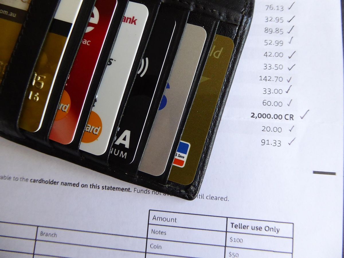 Open wallet of cards resting on a bank statement